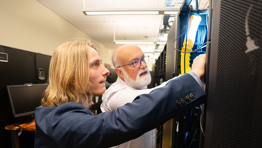 Image of Noah Yurasko and Professor Chris Algozzine working in the Enterprise Computing Research Lab.