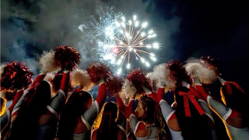Image of Marist Cheerleading with fireworks at Marist. Photo by Carlisle Stockton.
