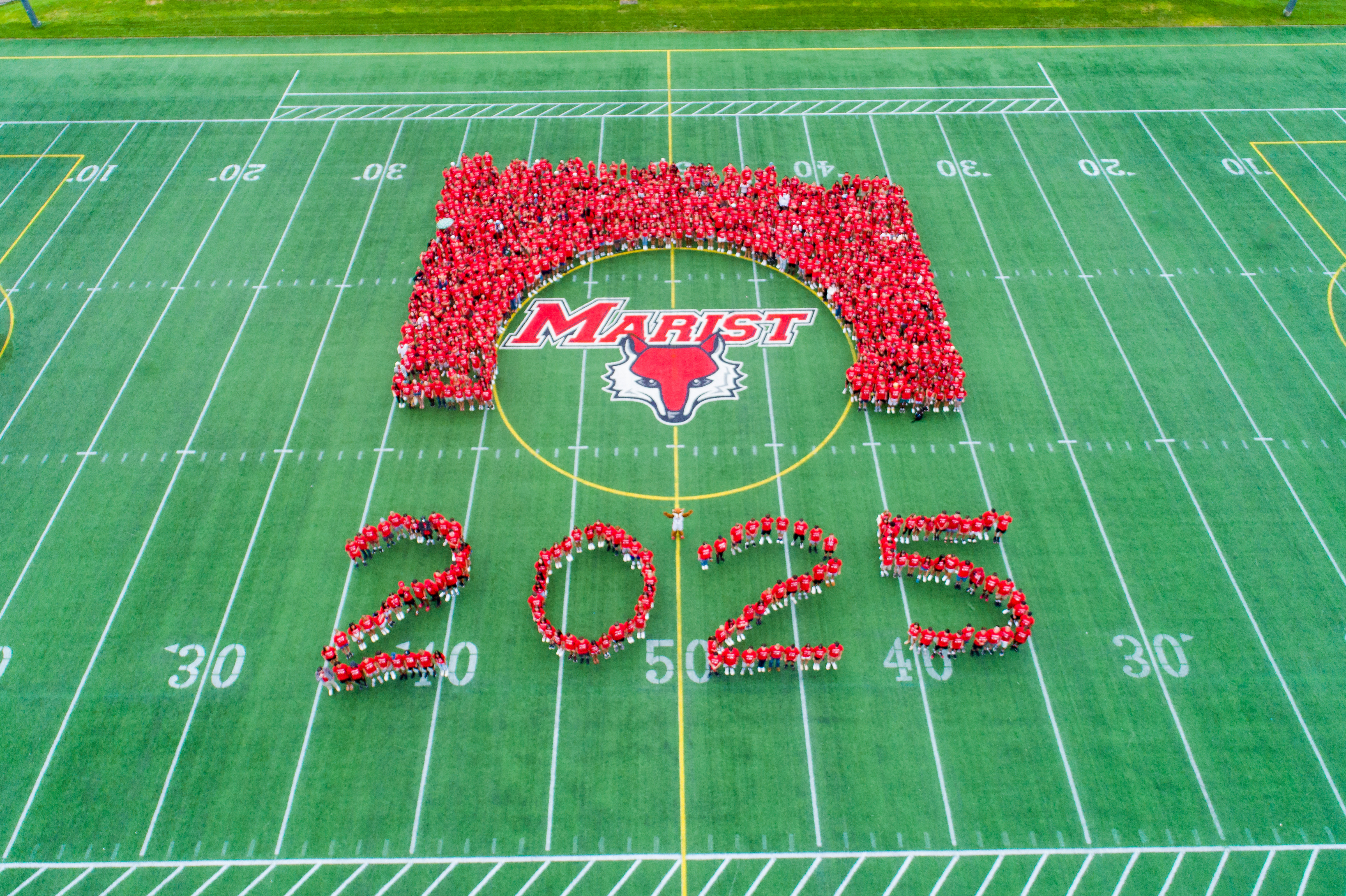 students making the 2025 symbol