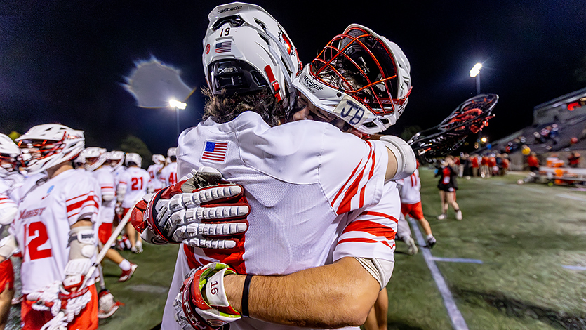 Lacrosse teammates celebrating. Photo by Carlisle Stockton for Marist University Athletics.