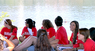 An image of pre-college students outside by the river. 