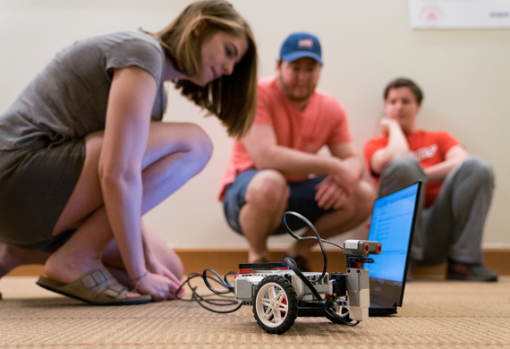 Image of students working collaboratively in a robotics competition.