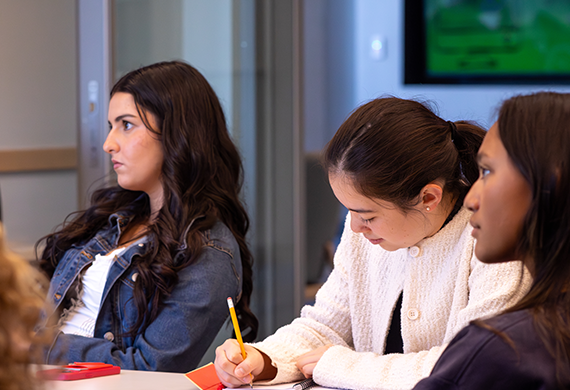Image of Marist University students sitting in class taking notes.