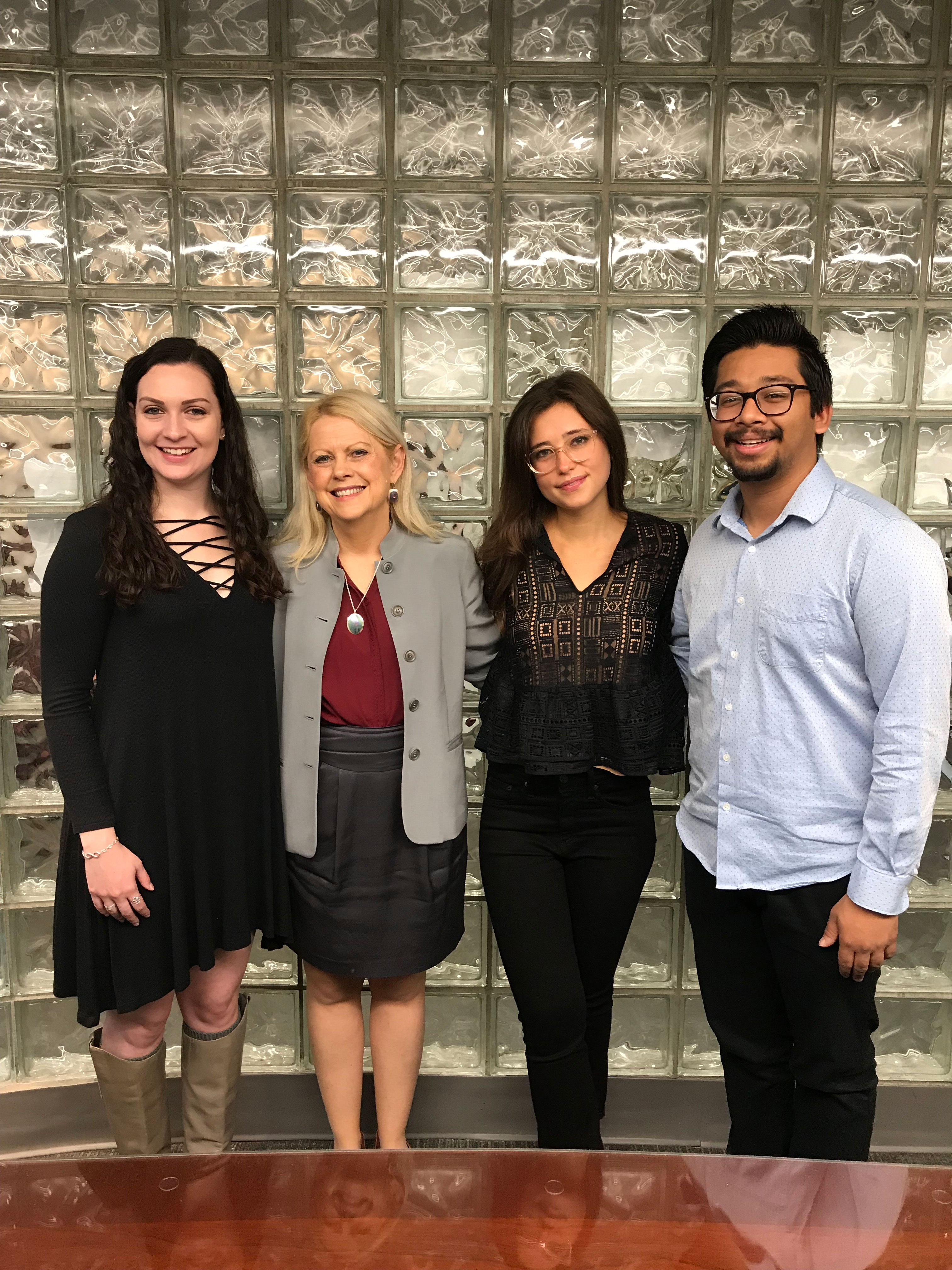 Photo of Melinda Weisberg standing with students