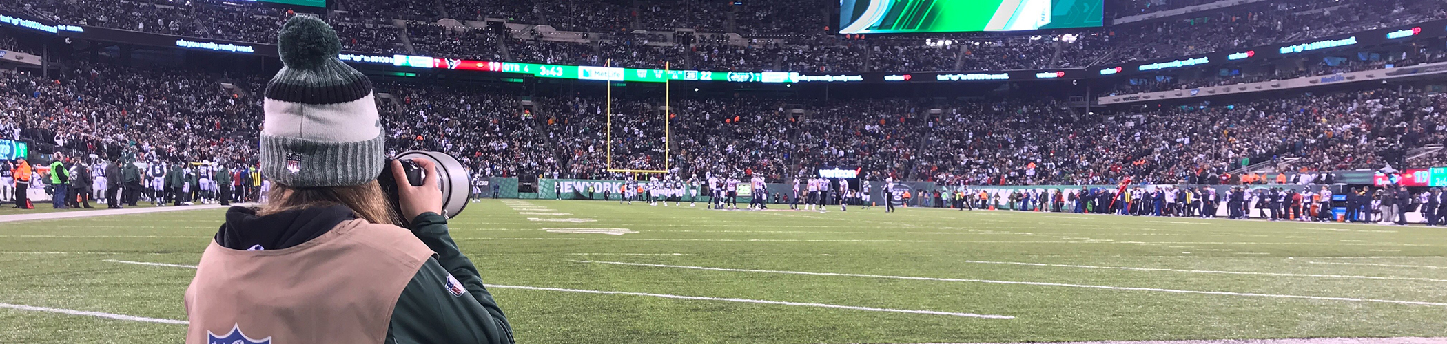 Photo of student Gabriella Ricciardi photographing Jets game