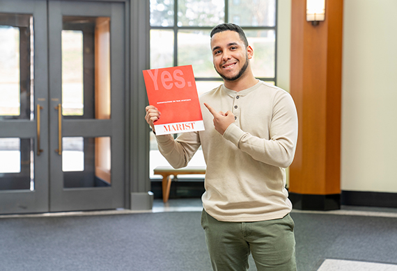 An image of a student holding an appendance packet. 