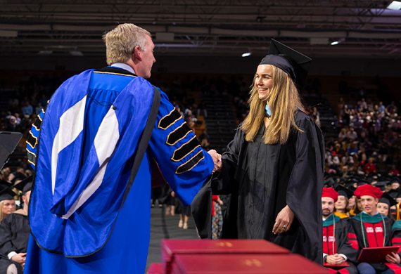 President Weinman and graduate student at Friday's Commencement.