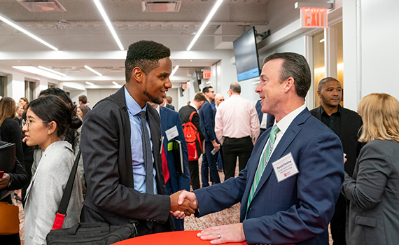 Student shaking hands with employer at NYC Career Trek
