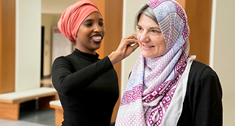 Image of student and faculty interacting.