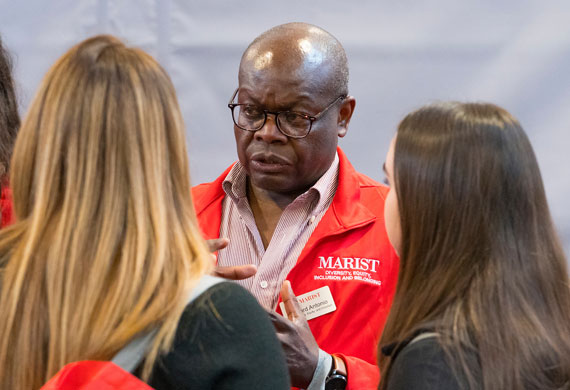 Image of Vice President for Diversity, Equity and Inclusion Doctor Edward Antonio speaking with a family.