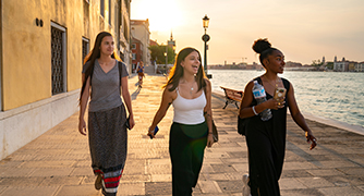 Three women walking in Italy