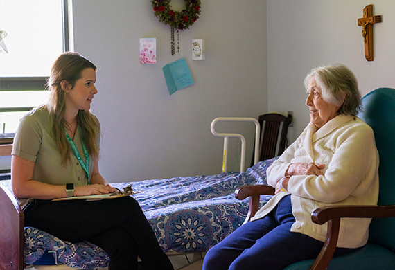Image of a master of social work student working with a client in her room.