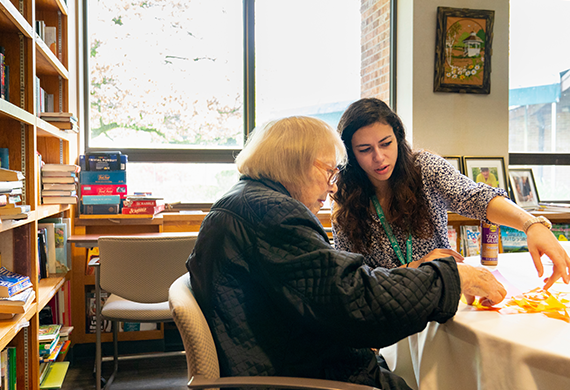 Image of a masters program social work student working alongside a client. 