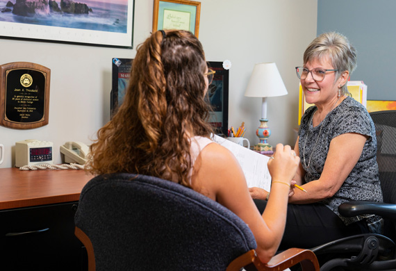 Image of faculty member meeting with a student.