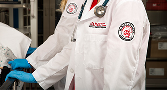 Photo of closeup of students badge on lab coat