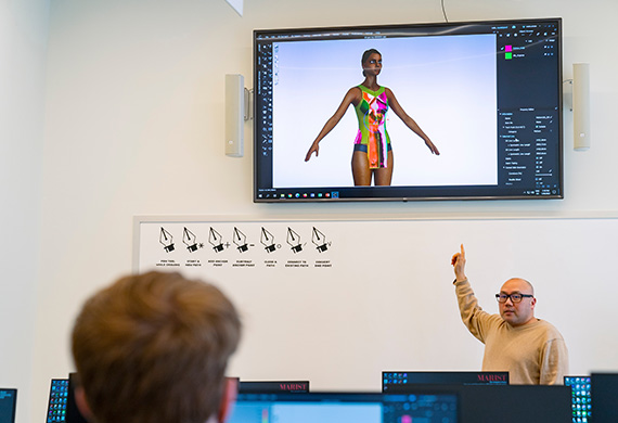 Image of faculty member presenting to a class in the Steel Plant Studios.