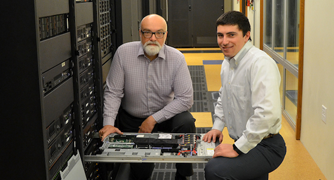 Image of faculty member and student working in the cloud computing lab.