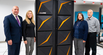 Image of Marist and IBM staff receiving a new piece of equipment.