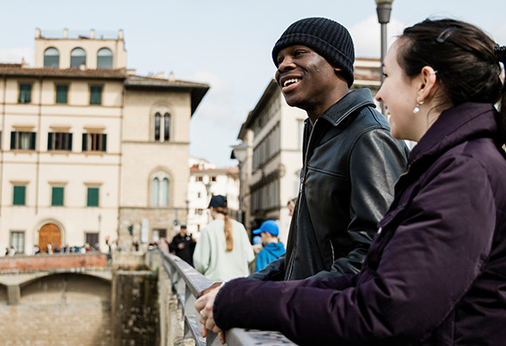 image of two people standing at bridge in Italy.