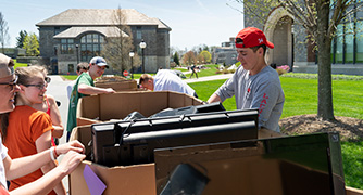 Photo of students recycling electronics