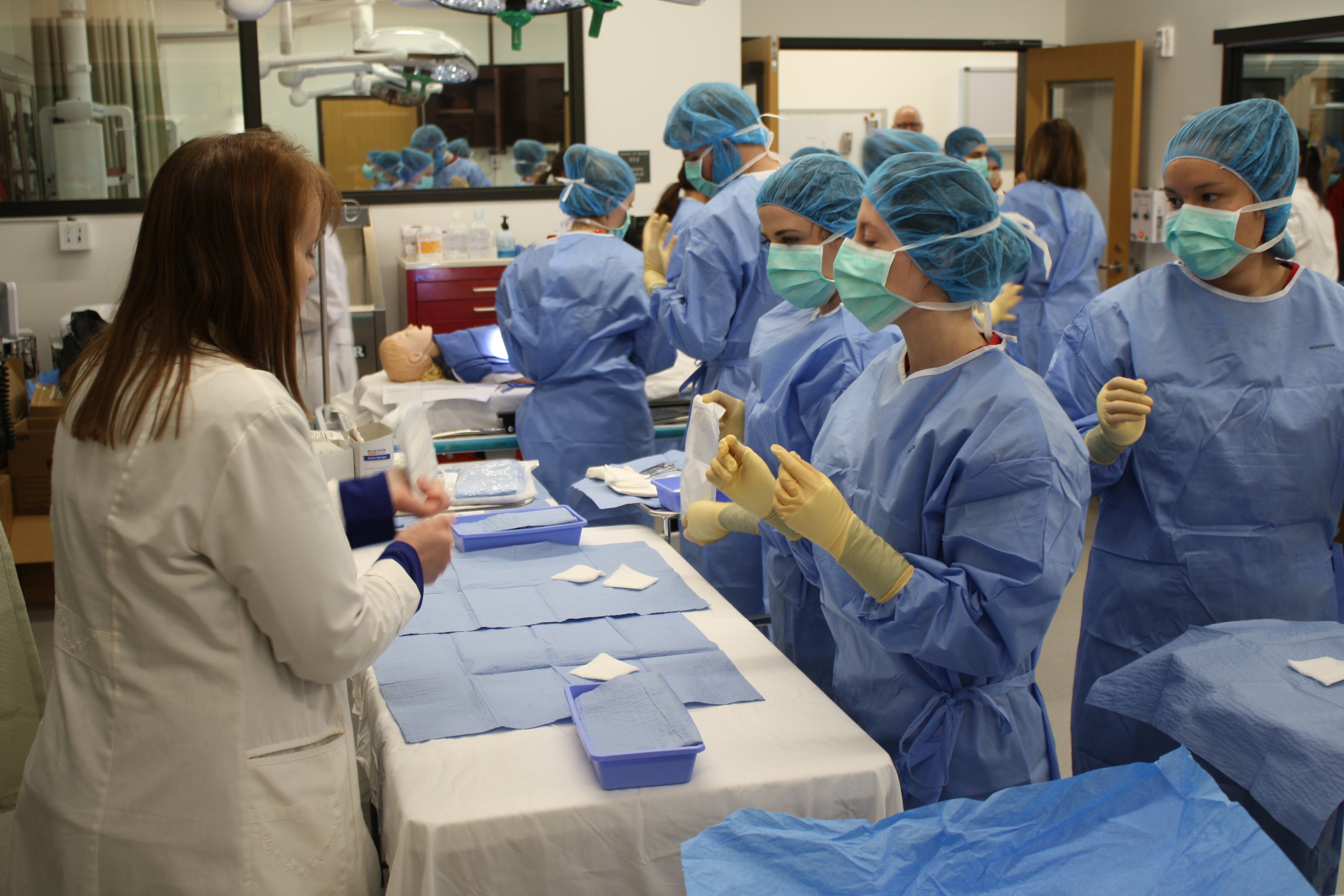 Photo of PA students scrubbing, gowning, and gloving with Nuvance Health System