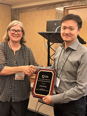 SET President Robyn Raschke presents the Outstanding Dissertation Award to Feiqu Huang