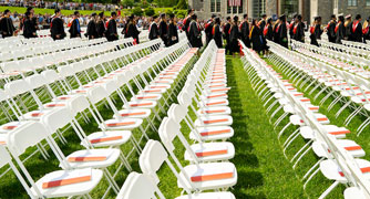 Image of commencement chairs on the campus green.