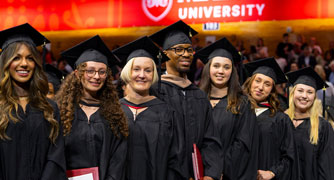Image of Marist University graduate students at commencement in McCann Arena.