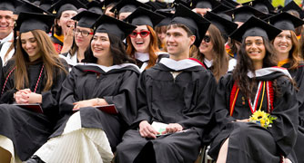 Image of Marist University undergraduate students at commencement on the campus green.
