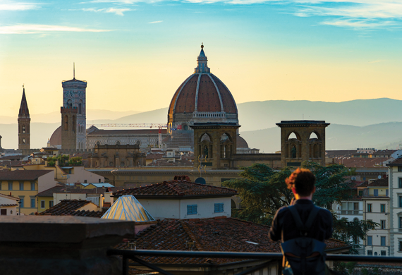 Image of a student looking out on the Florence skyline.
