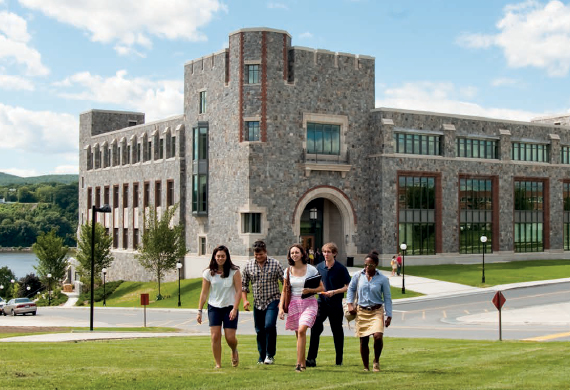 Image of students walking through a green space on campus.