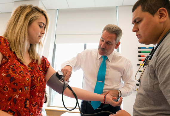 An image of faculty member demonstrating use of medical equipment during class.