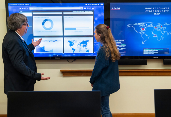 Image of cybersecurity faculty member teaching a student.