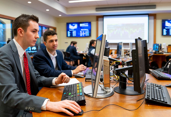 Image of Economics program students working in the Investment Center, colleges for economics
