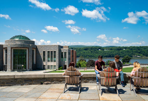Students sitting outside and talking to each other
