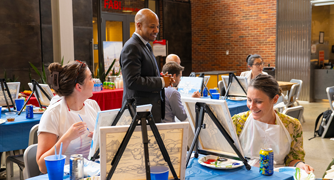 Image of Marist University faculty members at a paint party.