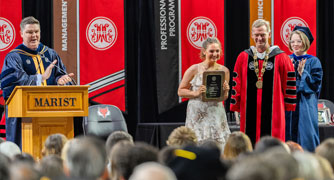 Image of a student being recognized at a academic achievement celebration. 