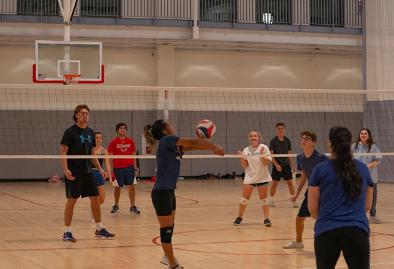 An image of students competing in intramural volleyball.