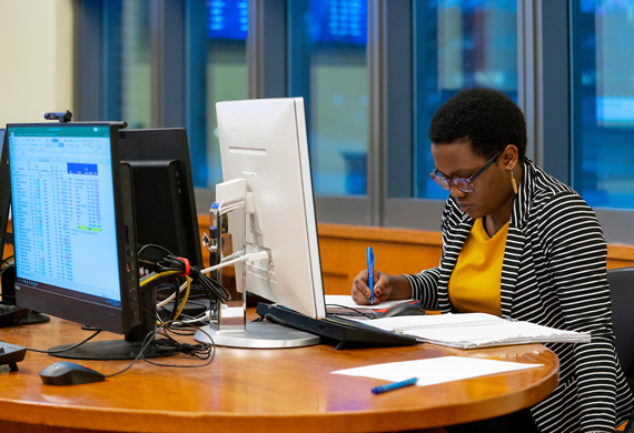 Image of a student working in the investment center on campus.