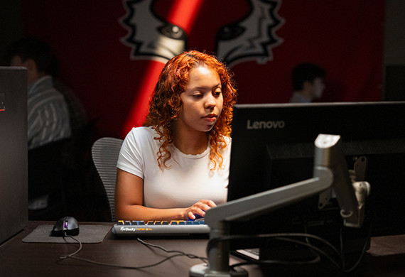 Image of a Marist University student sitting at computer.
