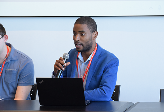 An image of a student speaking into a microphone 