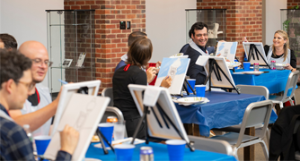 Image of faculty members at a paint night event.