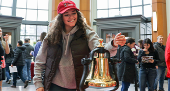 Image of student ringing the deposit bell