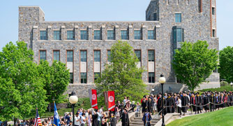 Image of the commencement procession entering the graduation site.