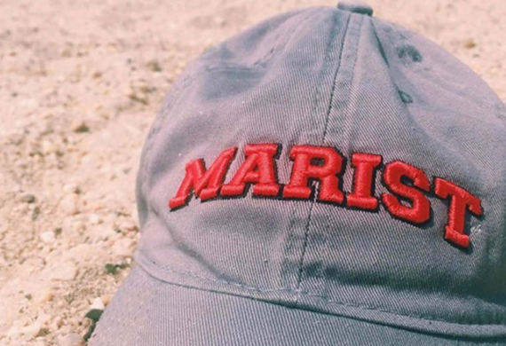 Image of a Marist hat on the beach.