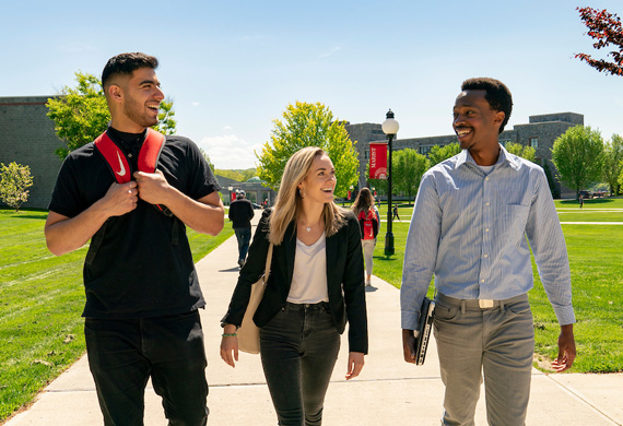 Image of students walking on campus on a sunny day.