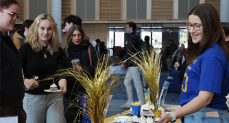Image of students at a recruitment event for a business honors society.