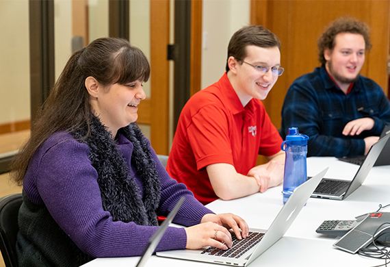 Image of Marist University' Data Science and Analytics students in front of their laptops.