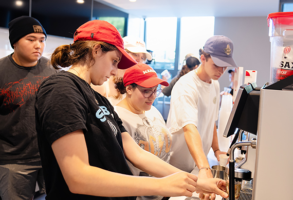 Image of students working behind the counter at Saxbys.