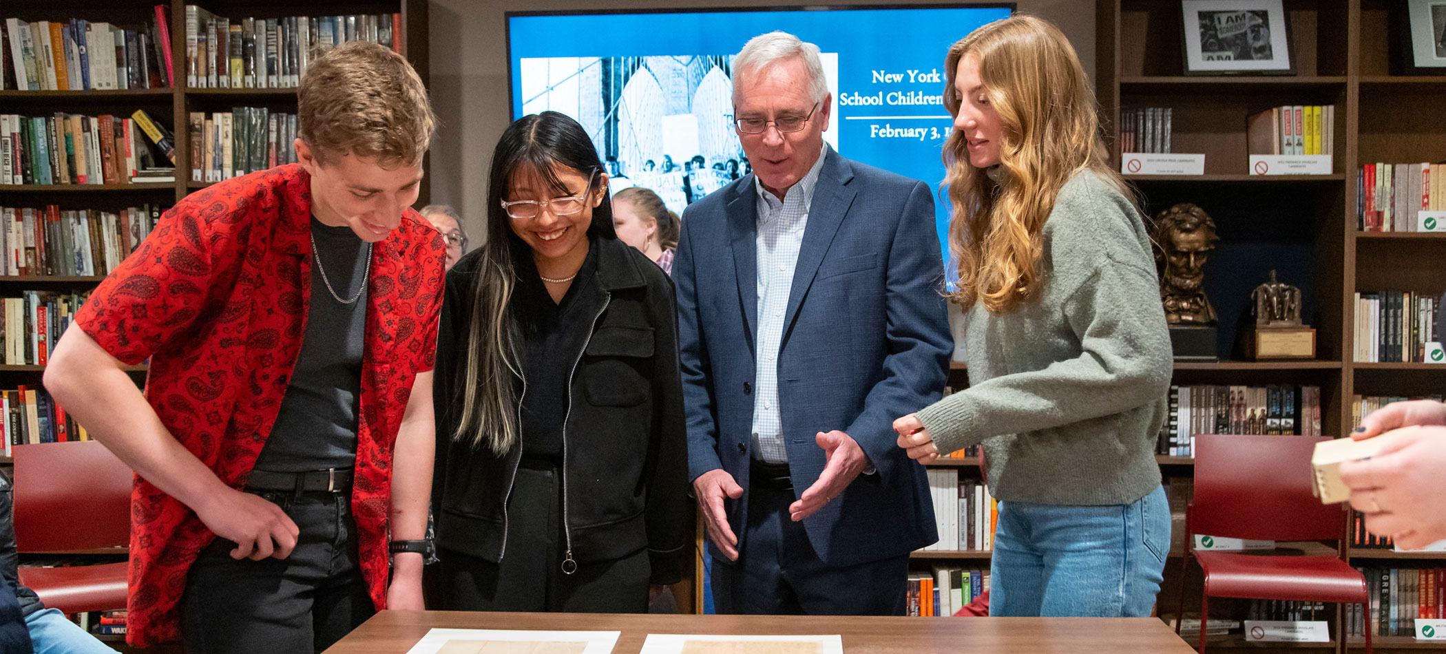 Image of Long Reach Society scholars looking at history documents.